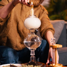 Load image into Gallery viewer, Person lighting a Infinity Waterfall Bong 11" Remastered Gravity Bong by Gypsy Labs with a blurred background